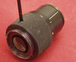 Lossening the set screws that retain the focus ring